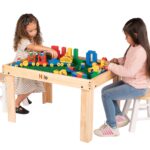 Children playing on the small Nilo lego duplo table with duplo blocks and Nilo double-sided Lego Duplo compatible baseplates..