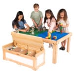 Four children playing with Lego and Duplo blocks on Large Nilo childrens play table and Nilo double-sided Lego Duplo compatible baseplates