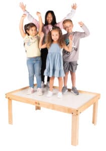 kids standing on sturdy Nilo wooden train table for kids