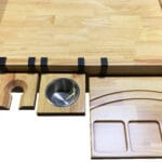 The nilo flip shelf, cup holder, and wine glass holder shown on the Nilo Master Table, a board gaming table.